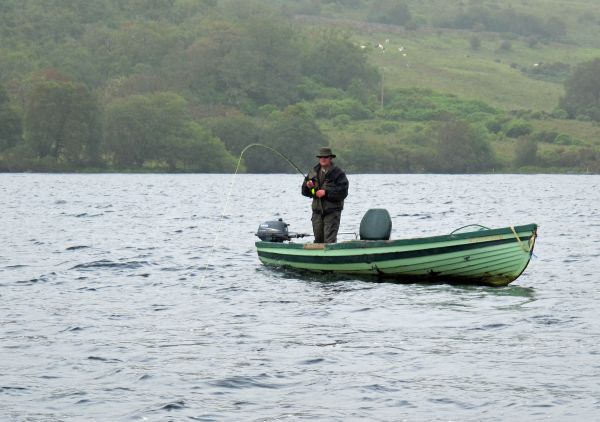 Our Guide Tommy playing another salmon on the lough